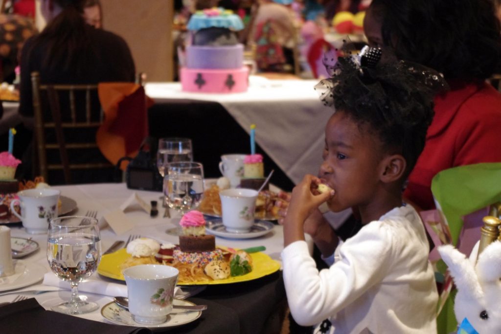 Guest enjoys Mad Hatter Tea Mad Hatter Tea at O.Henry Hotel