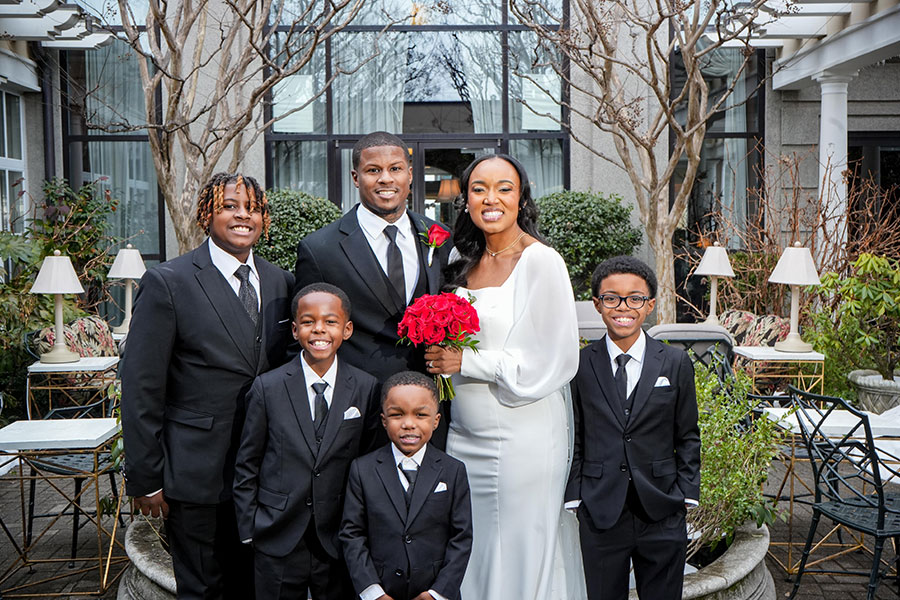 The Johnson Family | Still Shots Photography Latisha and Ronald with 4 of their 5 boys in the Cloister Garden at O.Henry Hotel