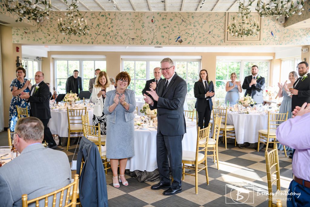 Family and friends welcome Kim and Jim as they enter the reception following the ceremony. Many of whom had been part of their journey decades ago and were there today. Photo by Brian Anthony Photography.
