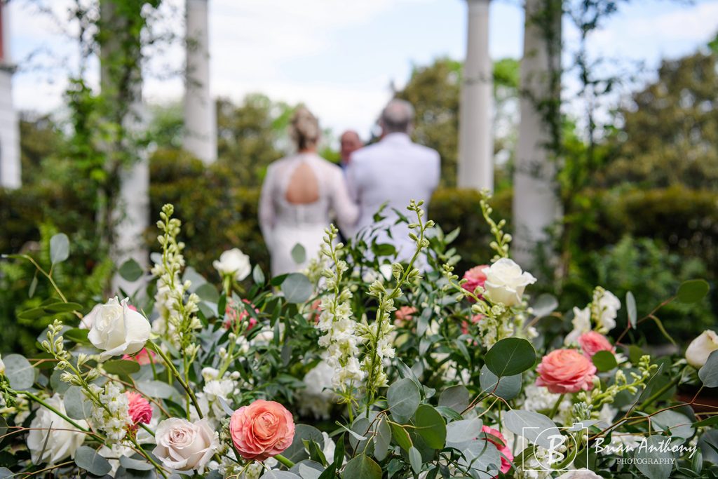 Fountain crowned with flowers for Cloister Garden Wedding Kim and Jim chose upgraded florals and Tom Gandy O.Henry Hotel's in-house designer did a marvelous job at realizing their vision. Photo by Brian Anthony Photography
