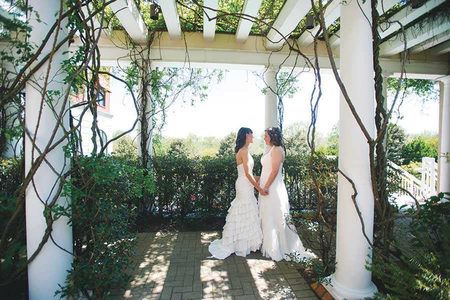 Newly married, a quiet moment in the Cloister Garden Lin and Caryanne, newly married, share a quiet moment under the arbor in the Cloister Garden at O.Henry Hotel