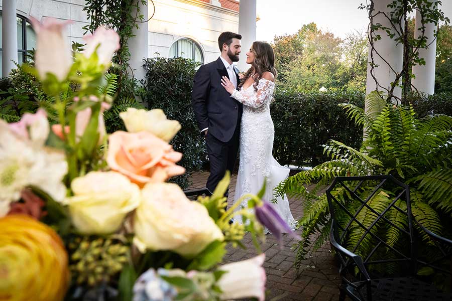Alex & Seth in the Cloister Garden | Micciche Photography Alex and Seth take photos in the Don Rives Cloister Garden after their wedding.